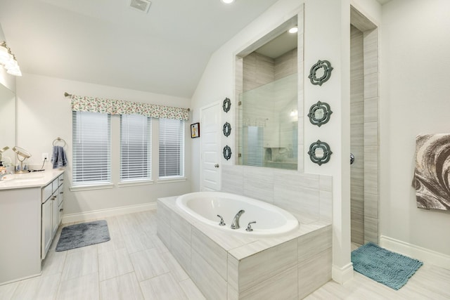 bathroom with vanity, shower with separate bathtub, and vaulted ceiling