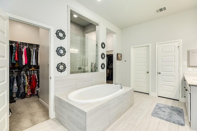 bathroom with vanity and separate shower and tub