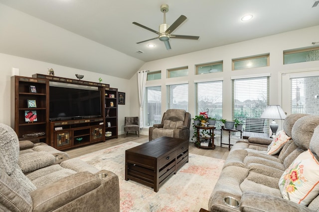 living room featuring light hardwood / wood-style flooring, ceiling fan, and vaulted ceiling