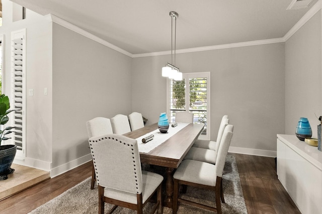 dining room with crown molding and dark hardwood / wood-style floors