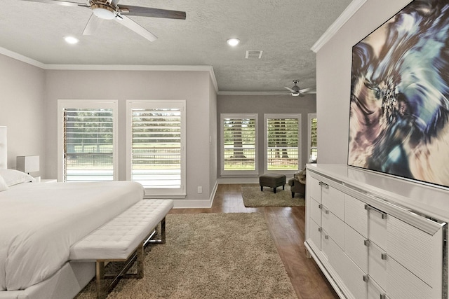 bedroom with ceiling fan, ornamental molding, dark hardwood / wood-style floors, and a textured ceiling