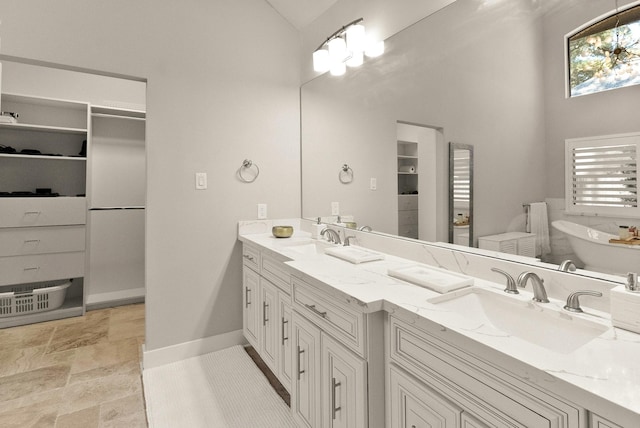 bathroom featuring a tub to relax in, high vaulted ceiling, and vanity