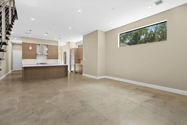 unfurnished living room with concrete floors