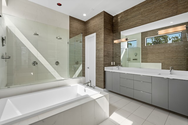 bathroom with tile patterned flooring, vanity, separate shower and tub, and tile walls