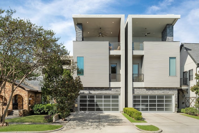 contemporary home with a garage and ceiling fan