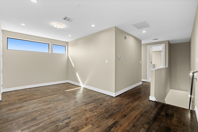 empty room with dark hardwood / wood-style flooring