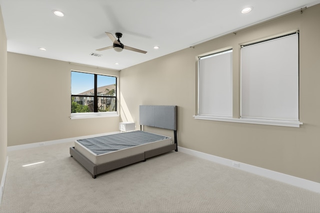 unfurnished bedroom with light carpet and ceiling fan