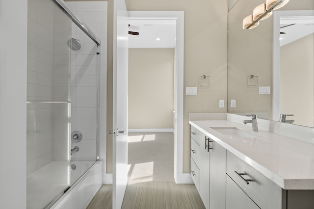 bathroom featuring vanity and combined bath / shower with glass door