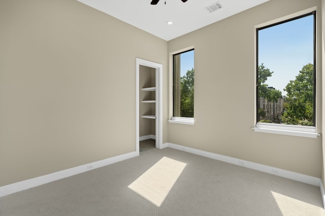 empty room with light carpet and ceiling fan