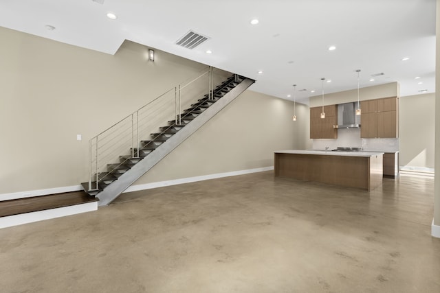 unfurnished living room featuring concrete flooring