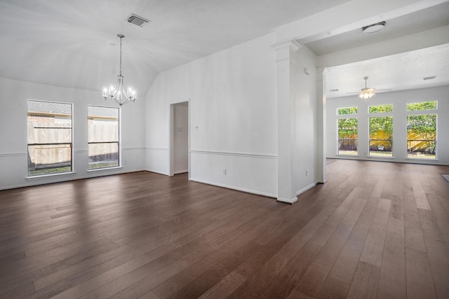 empty room featuring dark hardwood / wood-style flooring, ceiling fan with notable chandelier, and vaulted ceiling