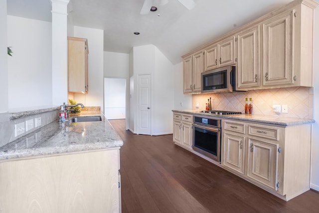 kitchen featuring sink, appliances with stainless steel finishes, backsplash, dark hardwood / wood-style floors, and light stone counters