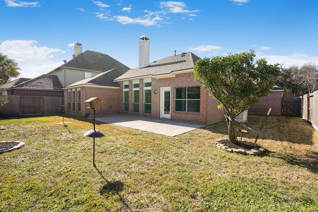 rear view of house with a yard and a patio