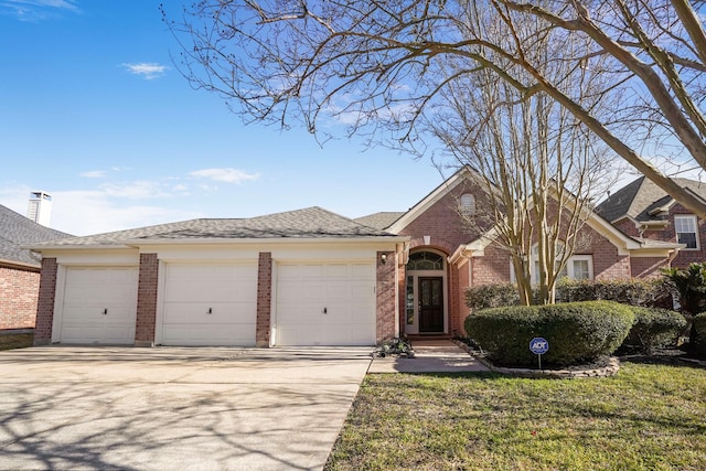 ranch-style house featuring a garage and a front yard