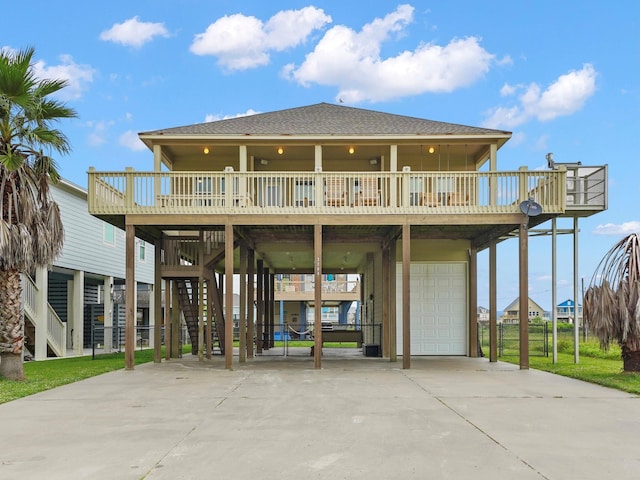 back of house featuring a garage and a deck