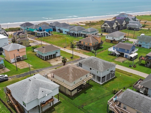 birds eye view of property with a beach view and a water view