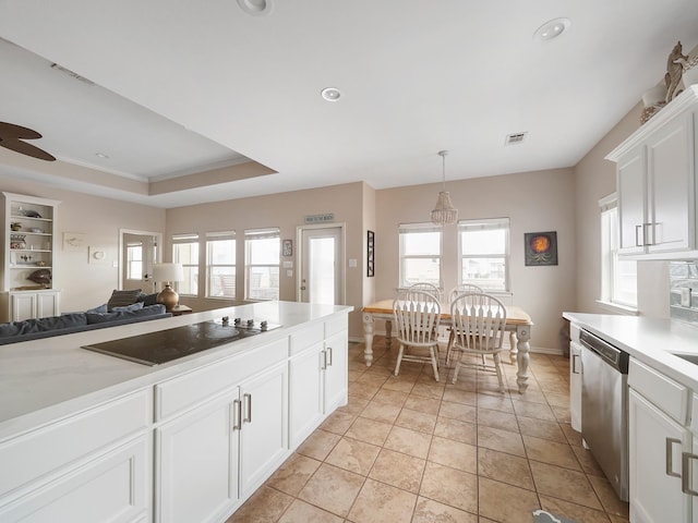 kitchen featuring white cabinetry, black electric stovetop, a tray ceiling, dishwasher, and a healthy amount of sunlight