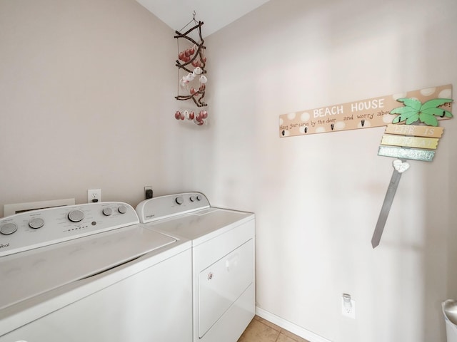 laundry room with light tile patterned floors and washing machine and clothes dryer