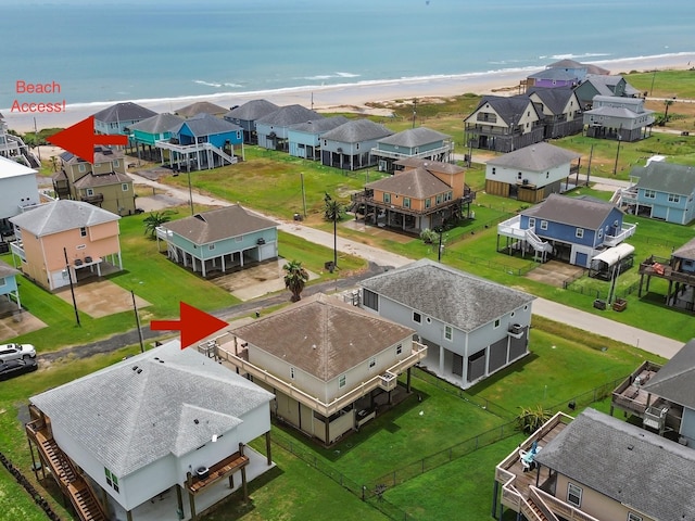 birds eye view of property with a water view and a view of the beach