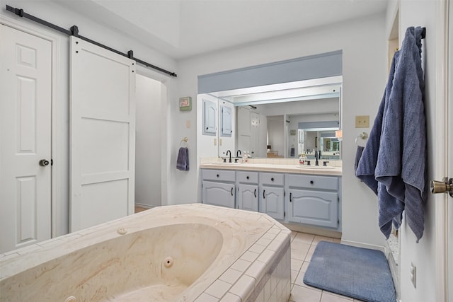 bathroom featuring vanity, a bath, and tile patterned flooring