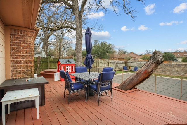 wooden deck with a storage shed