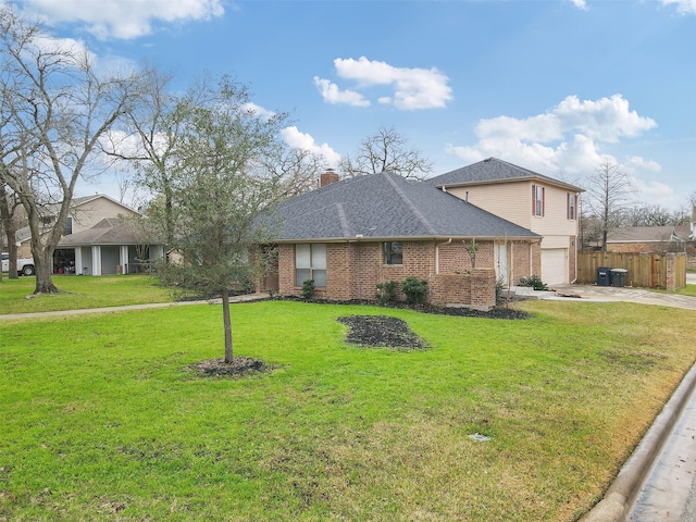 view of front of property featuring a front lawn and a garage