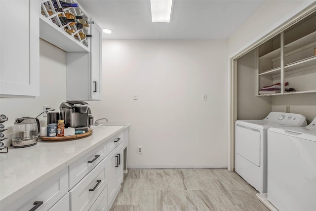 washroom featuring cabinets and independent washer and dryer