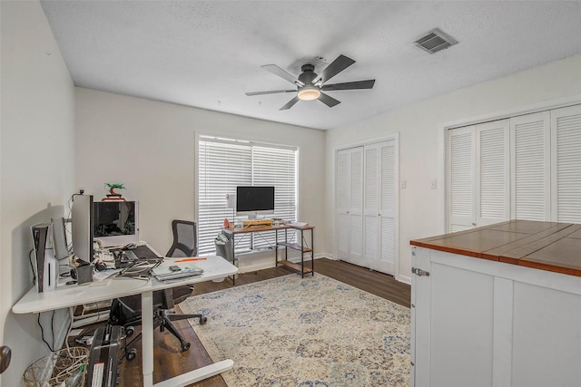 office area with hardwood / wood-style flooring, a textured ceiling, and ceiling fan