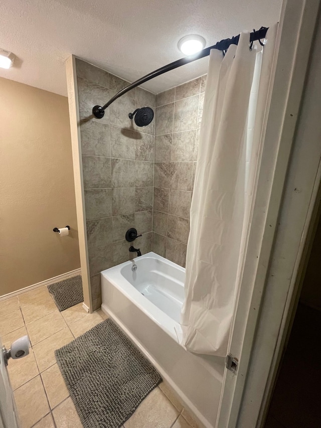 bathroom with a textured ceiling, tile patterned floors, and shower / bath combo