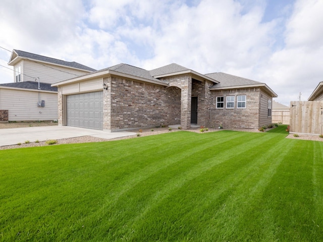 view of front of home featuring a garage and a front yard