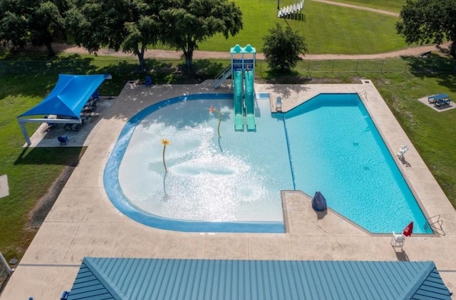 view of swimming pool featuring a yard and a patio