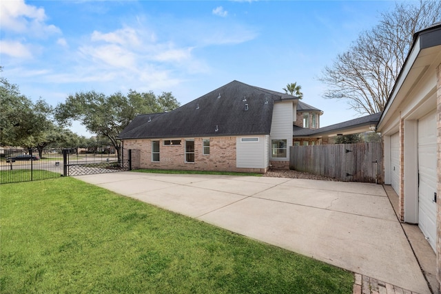 view of property exterior with a yard and a patio area