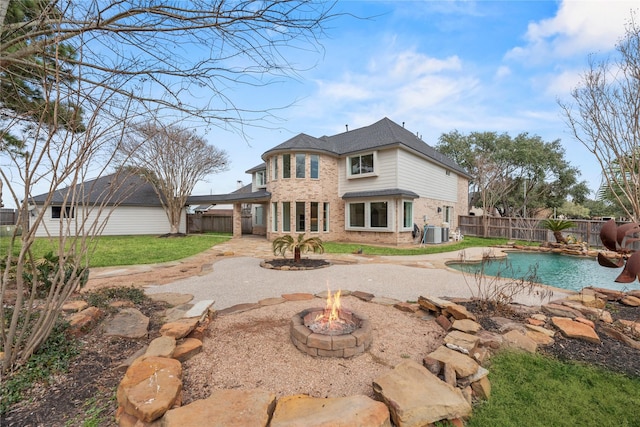 back of property featuring a fenced in pool, a patio area, central air condition unit, and a fire pit