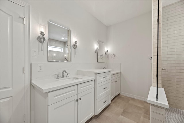 bathroom featuring vanity and tiled shower