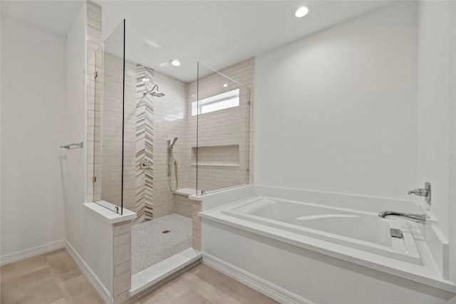 bathroom featuring separate shower and tub