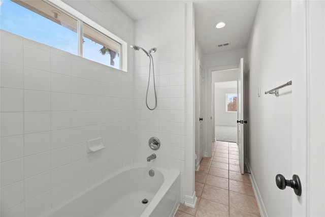 bathroom featuring tile patterned floors and tiled shower / bath combo