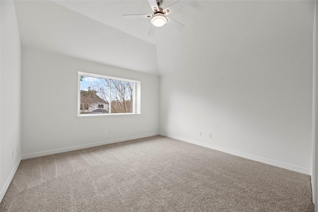 empty room with lofted ceiling, carpet floors, and ceiling fan