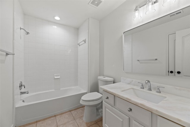 full bathroom with tile patterned flooring, vanity, toilet, and tiled shower / bath