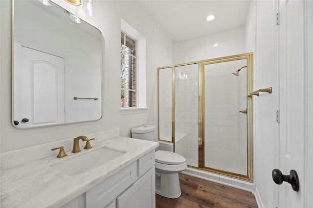 bathroom with vanity, toilet, hardwood / wood-style floors, and walk in shower