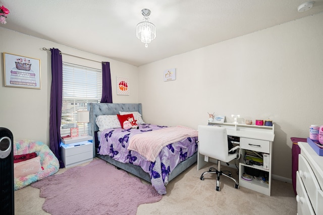 bedroom with light carpet and a notable chandelier