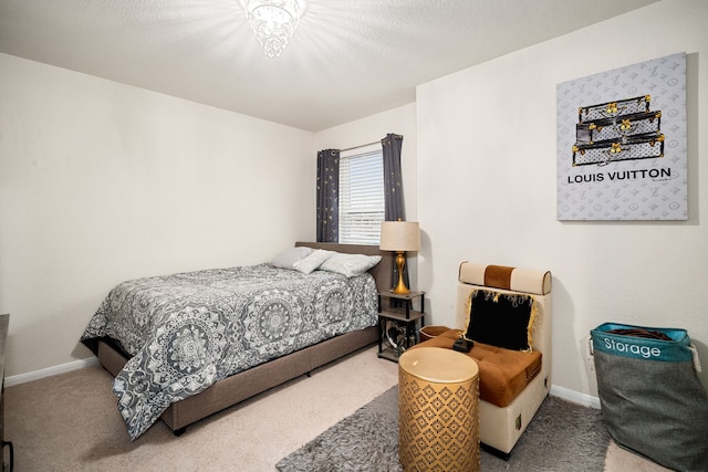 bedroom with carpet and a textured ceiling