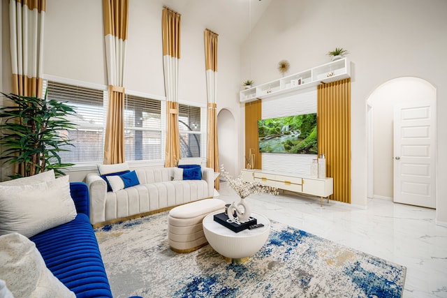 living room with high vaulted ceiling