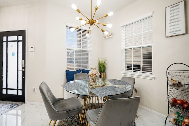 dining space with a wealth of natural light and a chandelier