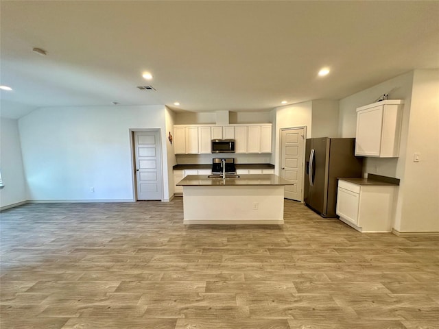 kitchen featuring white cabinetry, stainless steel appliances, a kitchen island with sink, and light wood-type flooring