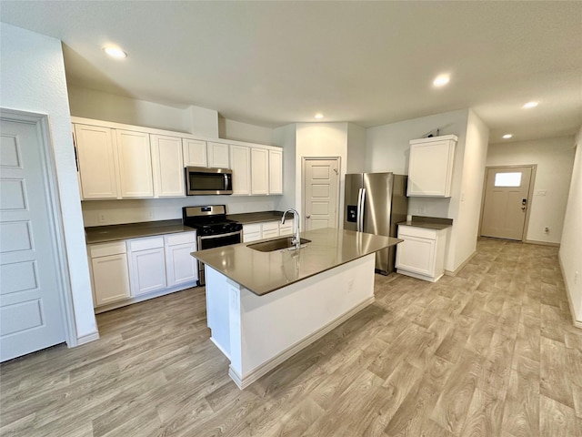 kitchen with stainless steel appliances, sink, and white cabinets