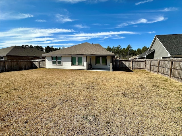 back of property featuring a yard