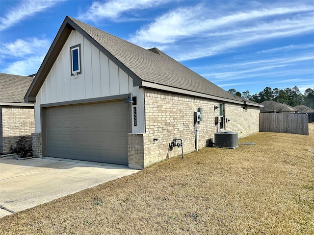 view of side of home featuring central AC unit and a lawn