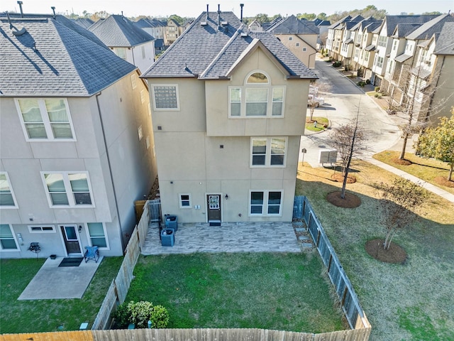 back of house with a yard and a patio area