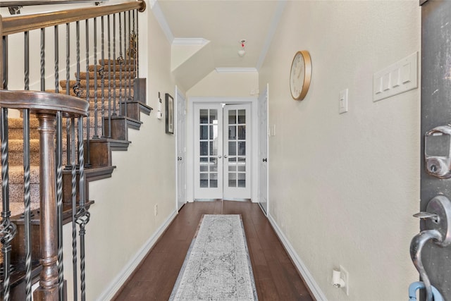 entrance foyer with crown molding, dark hardwood / wood-style flooring, and french doors