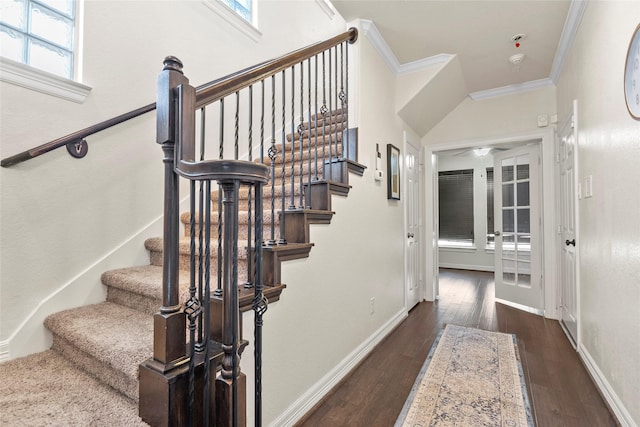 staircase with crown molding and hardwood / wood-style floors